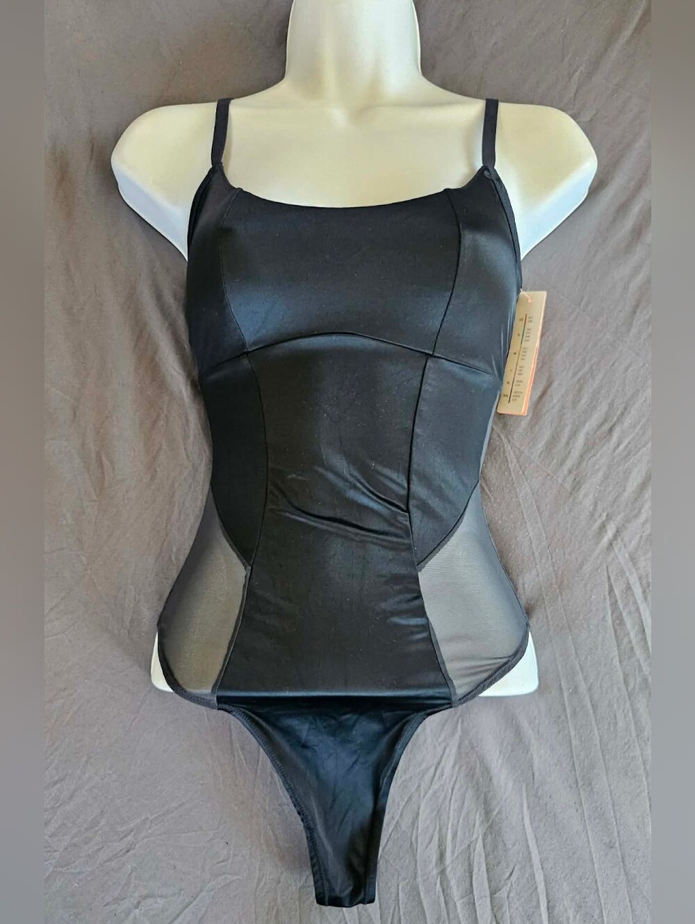 Black bodysuit with mesh panels and adjustable straps, size small, brand new